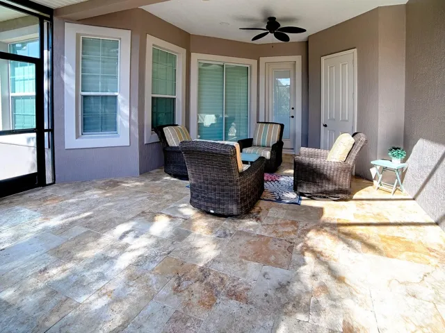 AROUND THE CORNER IS ANOTHER SEATING AREA, A STORAGE ROOM FOR ALL YOUR POOL EQUIPMENT, A POOL BATH AND THE SLIDING GLASS DOORS LEAD TO THE PRIMARY BEDROOM.