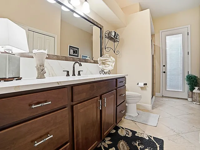 ACROSS THE HALLWAY FROM THE 3RD BEDROOM IS THE 3RD "POOL" BATH OFFERING ACCESS FROM THE INSIDE AND OUTSIDE.  THERE IS A SHOWER TO THE LEFT AND LARGE LINEN CLOSET ON THE RIGHT.