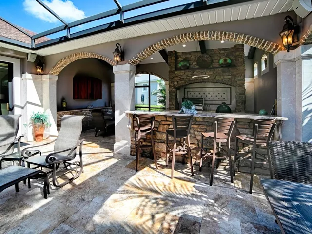 A GREAT PLACE FOR ENTERTAINING WITH THE SUMMER KITCHEN OFFERING AN ALFREDO GRILL AND REFRIGERATOR.