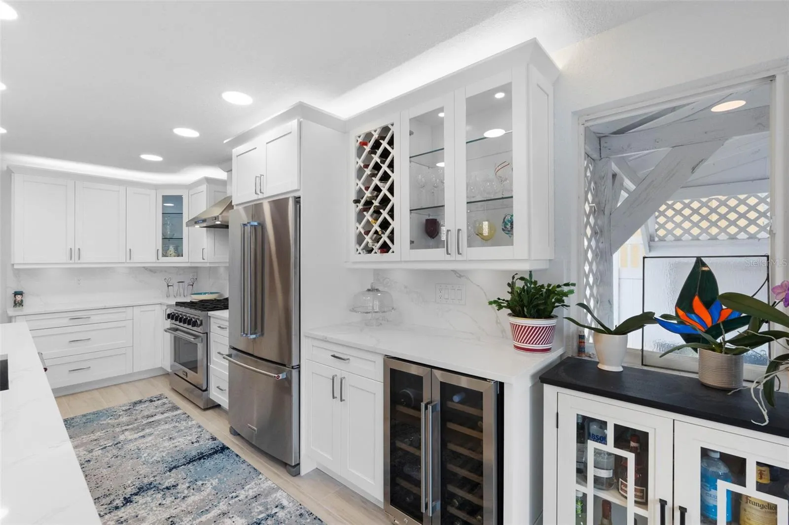 Stainless steel appliances including wine refrigerator.