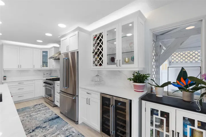 Stainless steel appliances including wine refrigerator.