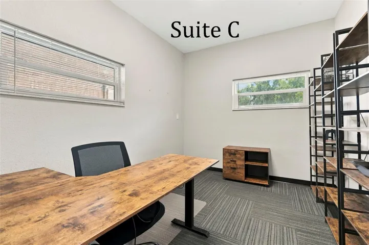 Suite C has 2 high windows and is located by the Coffee Station, Hall Restroom and Covered Patio Break Common Area