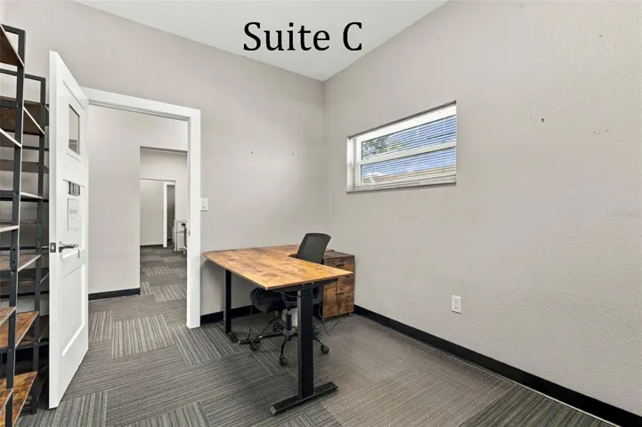 Suite C has 2 high windows and is located by the Coffee Station, Hall Restroom and Covered Patio Break Common Area