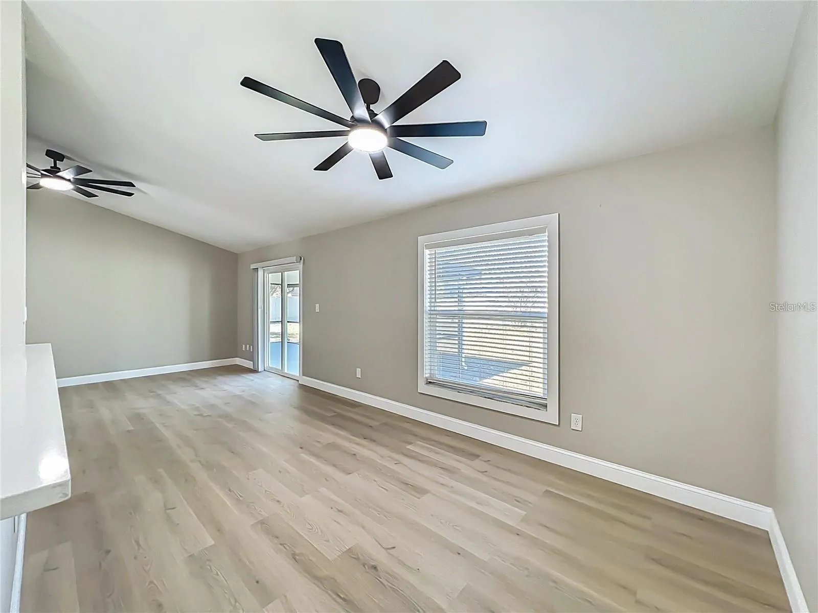 View from kitchen, dining area, sliding doors toward back yard.