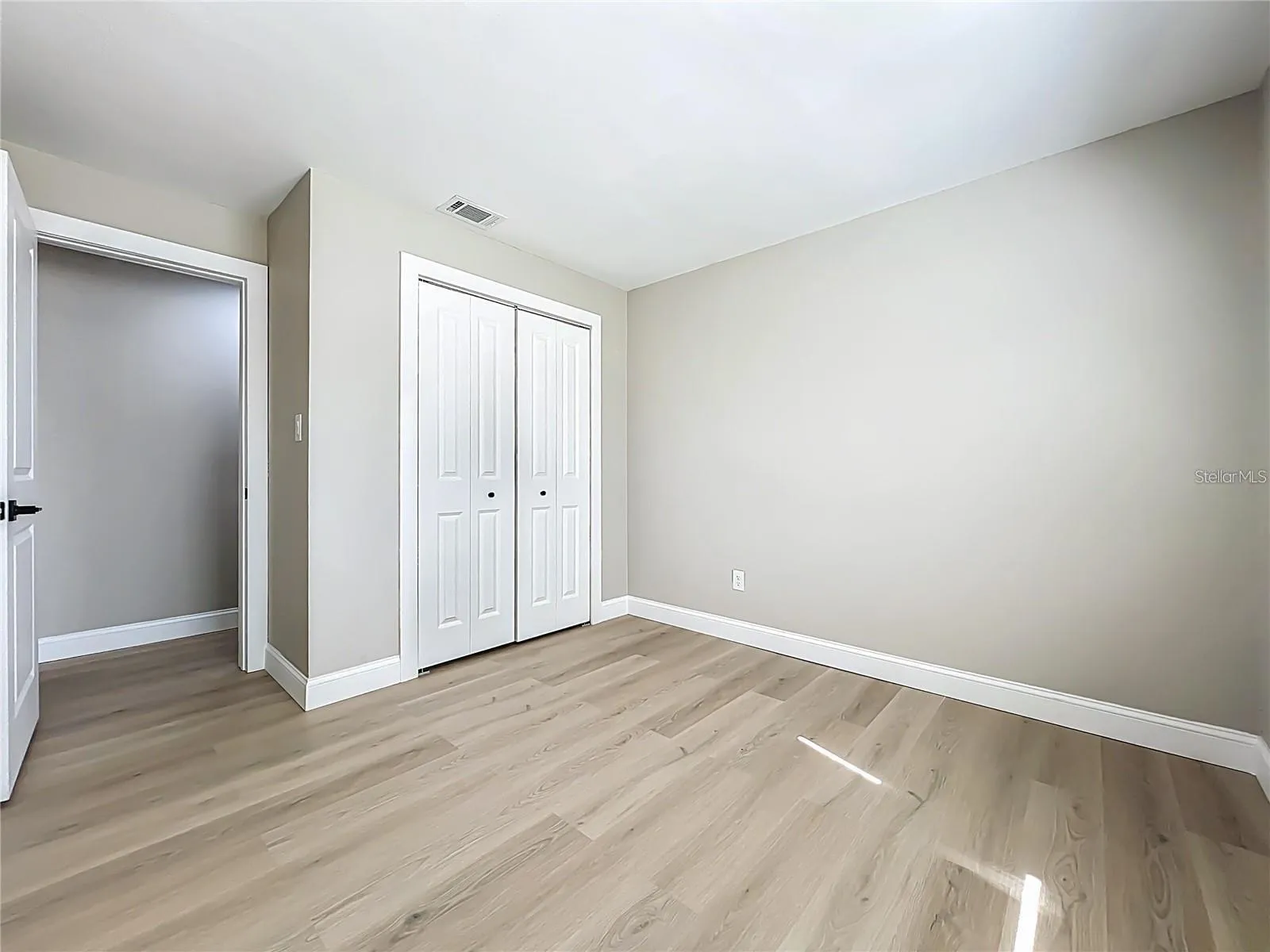 View of bedroom two toward entrance and closet.