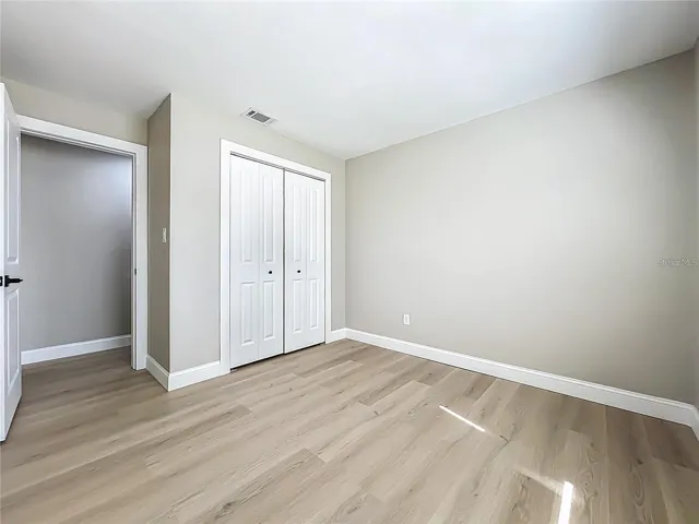 View of bedroom two toward entrance and closet.