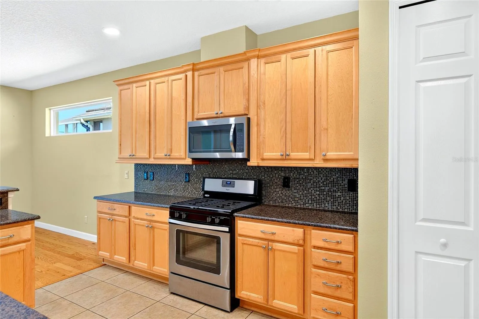Spacious kitchen with gas-burning stove.