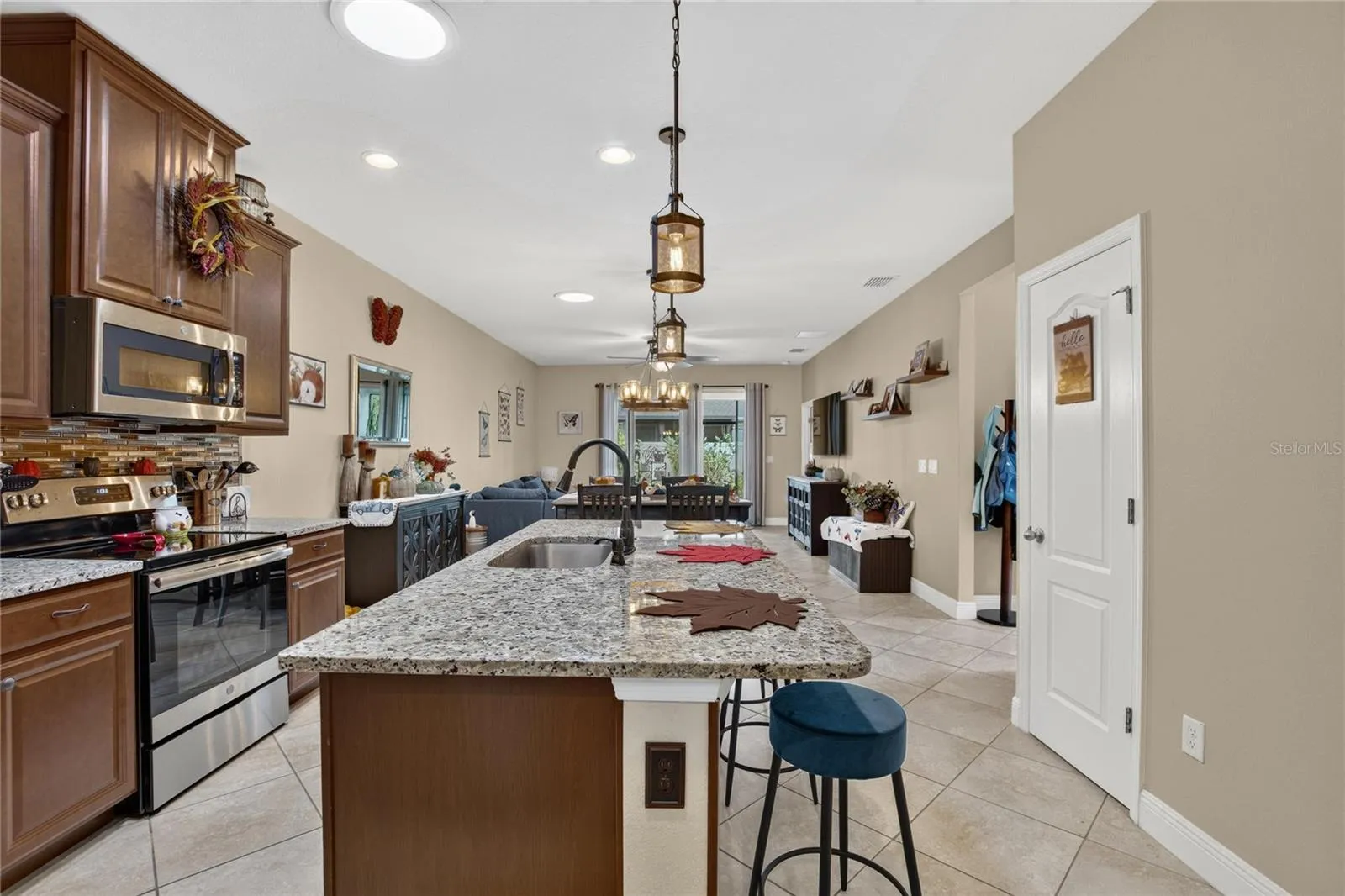 The open design keeps the cook connected to the conversation from the kitchen through the entire great room