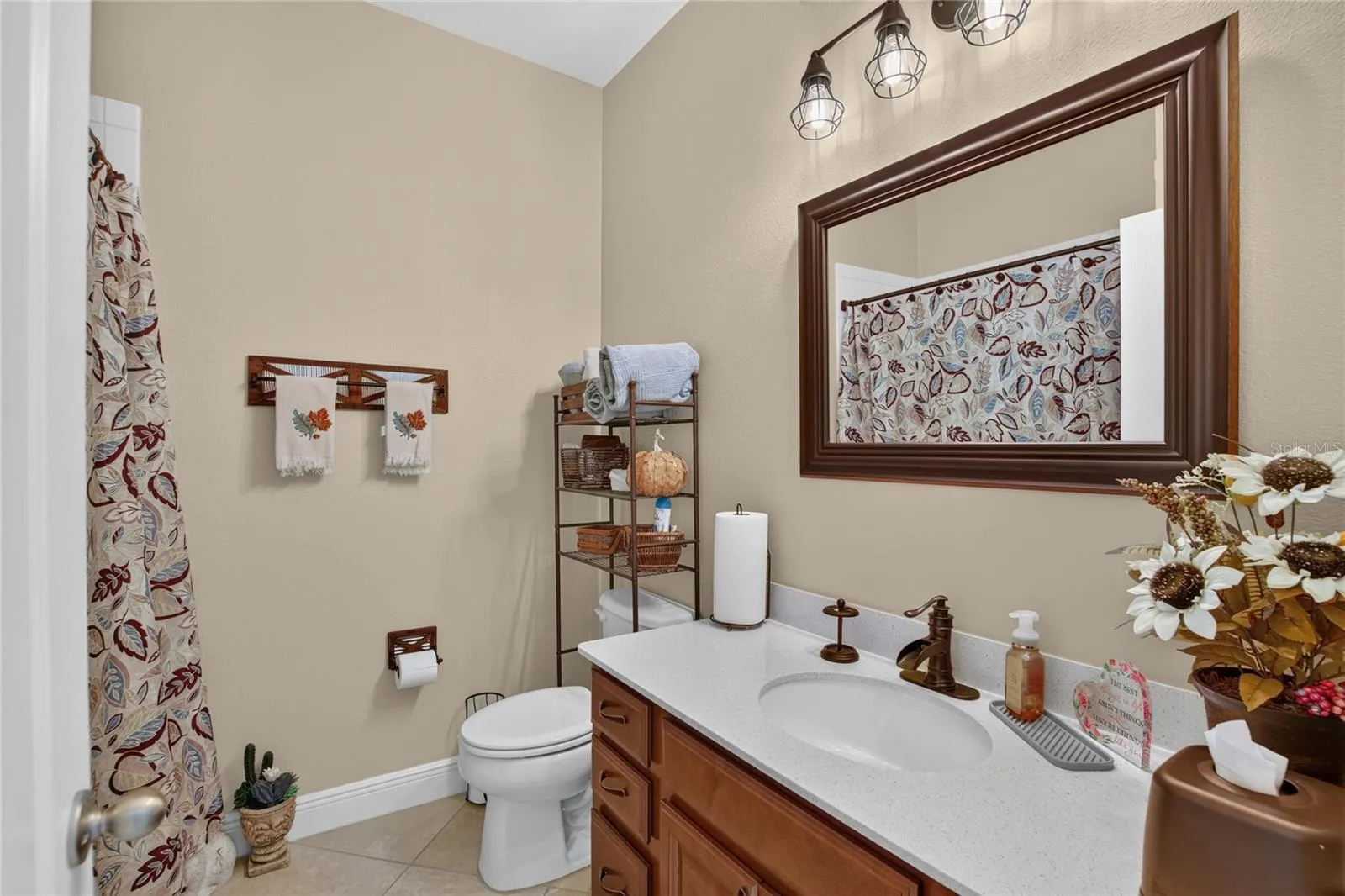 The secondary bath has been thoughtfully refreshed with updated lighting, mirror, fixtures and hardware