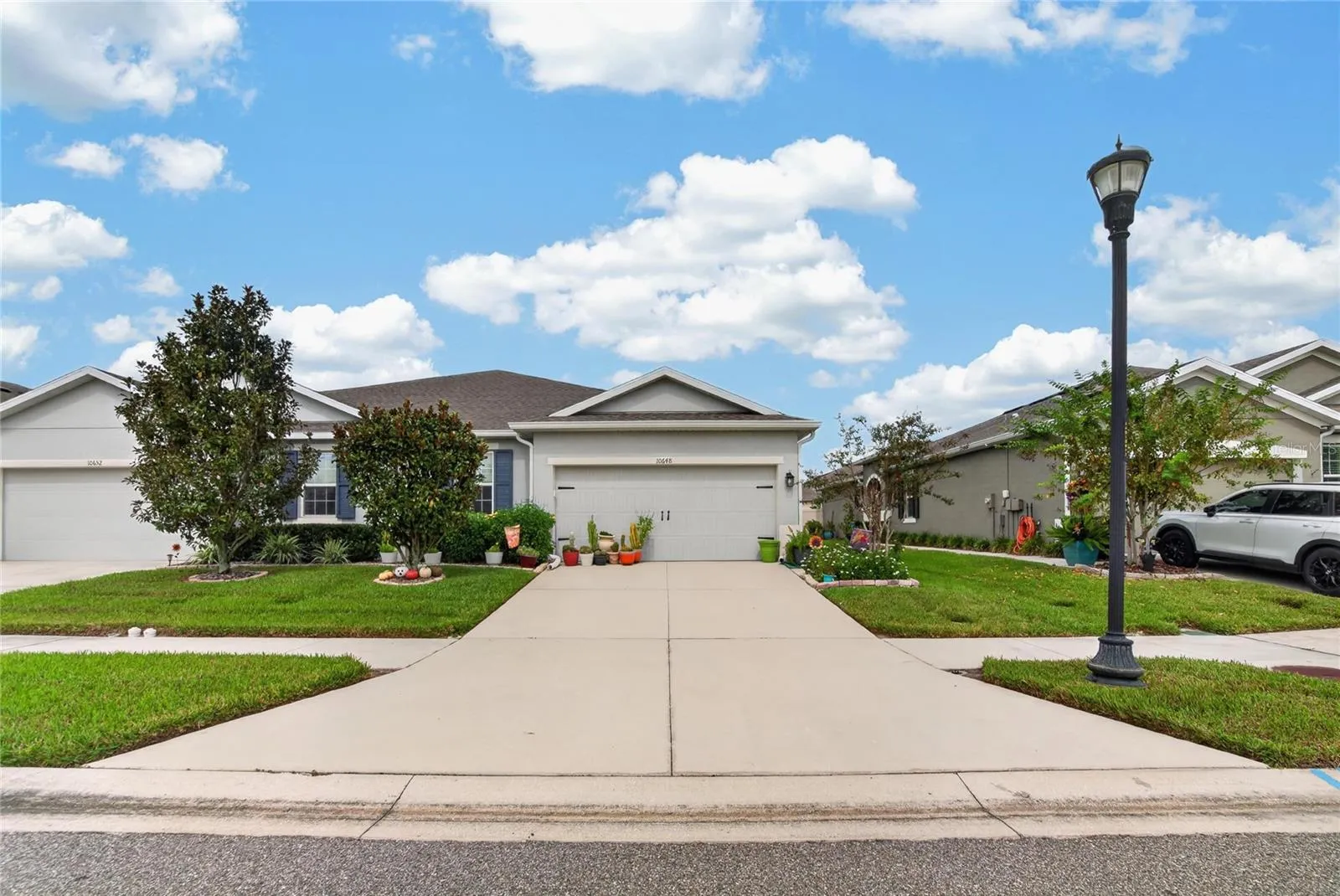 The full width street view shows the complete frontage and the home’s comfortable setting within the community