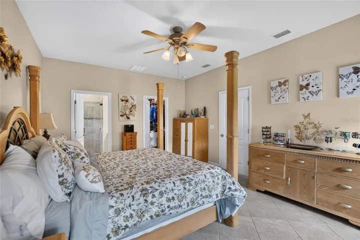 This reverse view shows the primary suite's comfortable proportions and convenient connection to the private bath