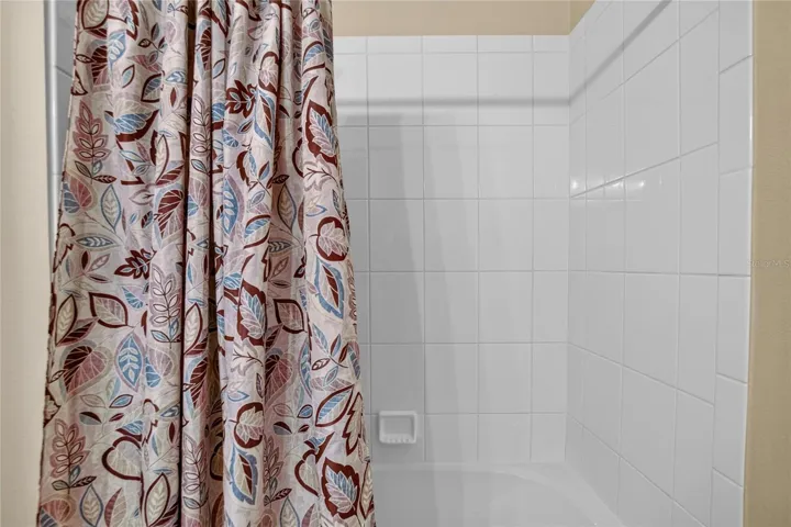 The secondary bath includes a full tub and shower combination, a practical feature for guests and everyday routines.