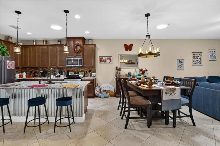 One bright, connected space brings the kitchen, dining area and living room together over beautiful diagonal tile