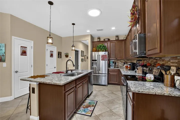 Generous counters, stainless appliances and a central island provide plenty of room for cooking, serving and gathering