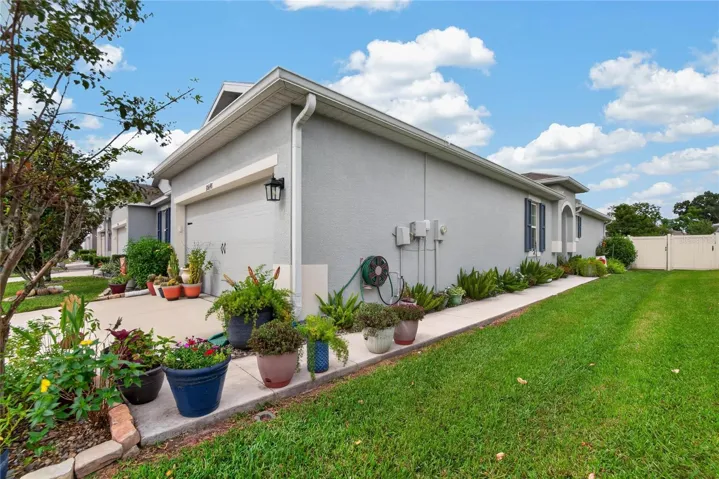The landscaped side walkway provides convenient fenced yard access and another view of the maintained exterior