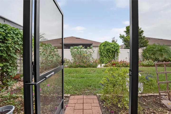 The screened lanai opens directly to a private six foot vinyl fenced backyard, convenient for pets and outdoor time