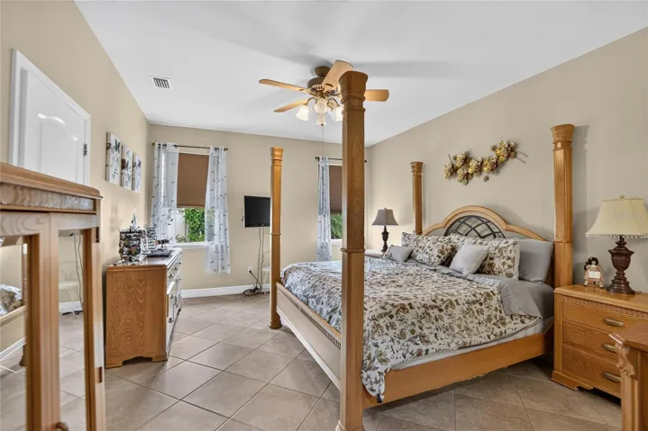 The generous primary suite combines natural light, tile flooring and room to create a peaceful retreat.