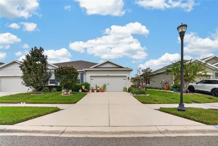 The full width street view shows the complete frontage and the home’s comfortable setting within the community