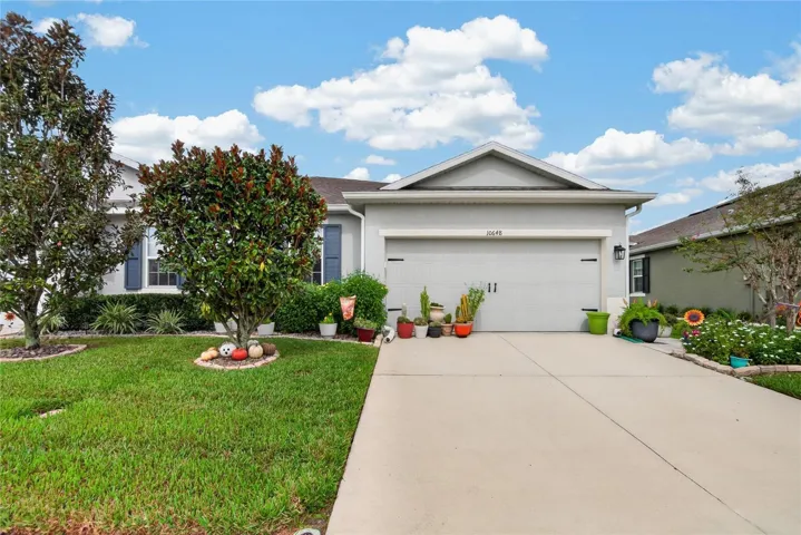 The front elevation presents a clean roofline, welcoming landscaping and an easy approach to the garage and entry.