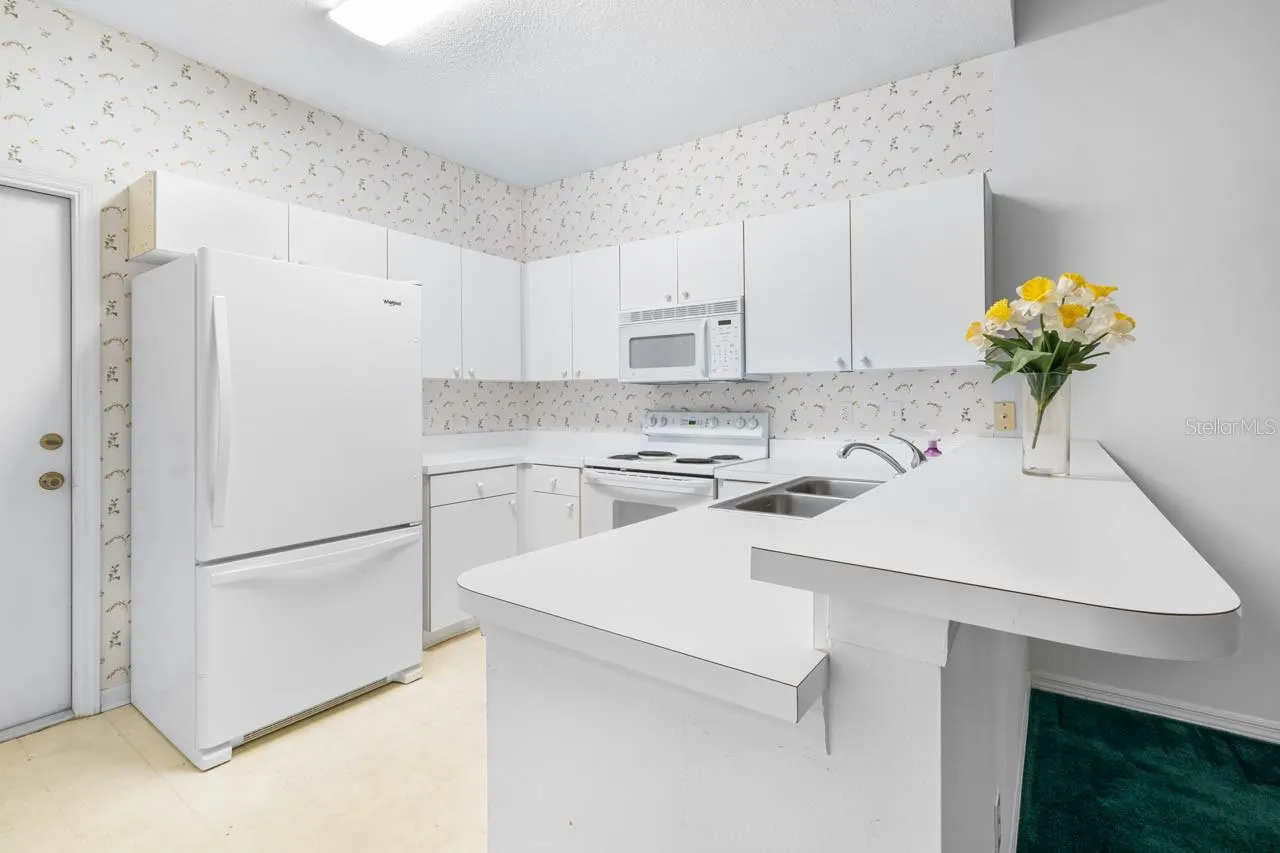 Kitchen with door leading to the garage