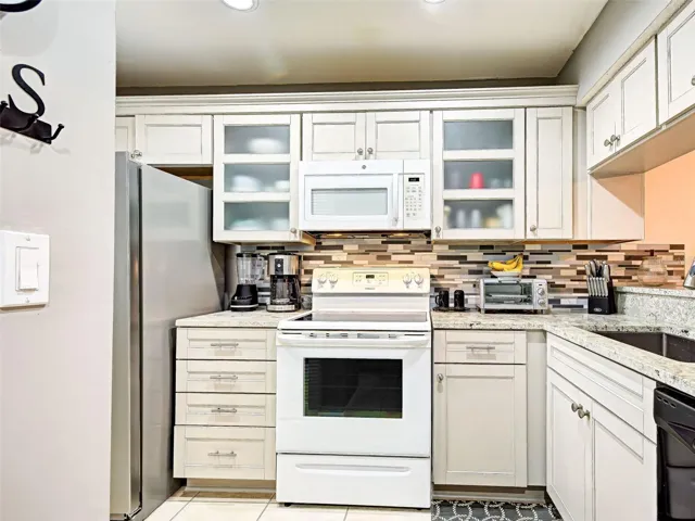 beautiful cabinetry features soft close doors and drawers with granite counter tops.