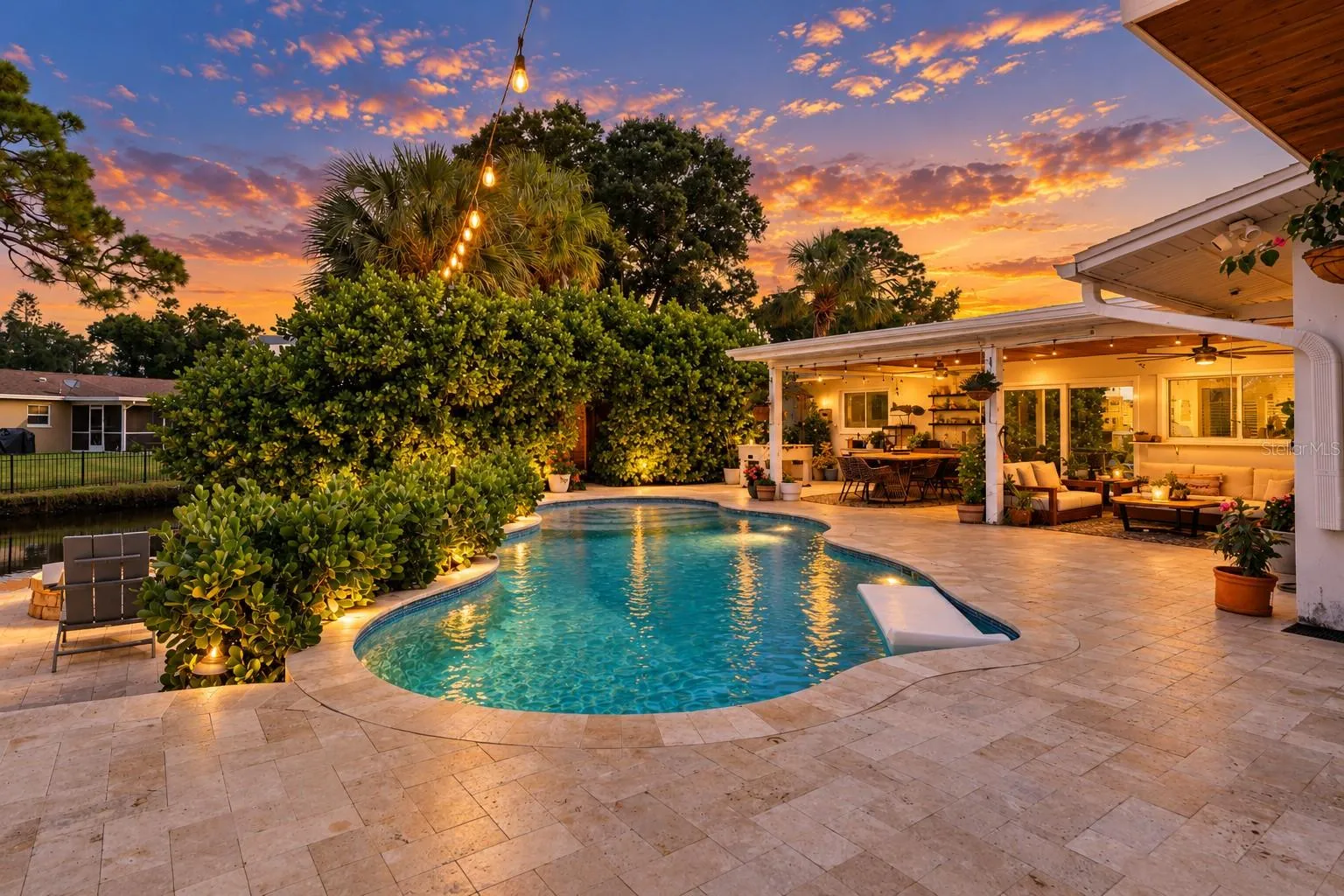 Twilight View of Saltwater Pool and Entertainment Space