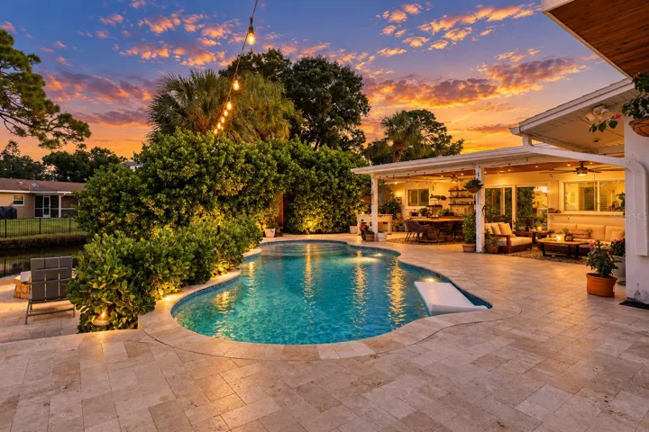 Twilight View of Saltwater Pool and Entertainment Space
