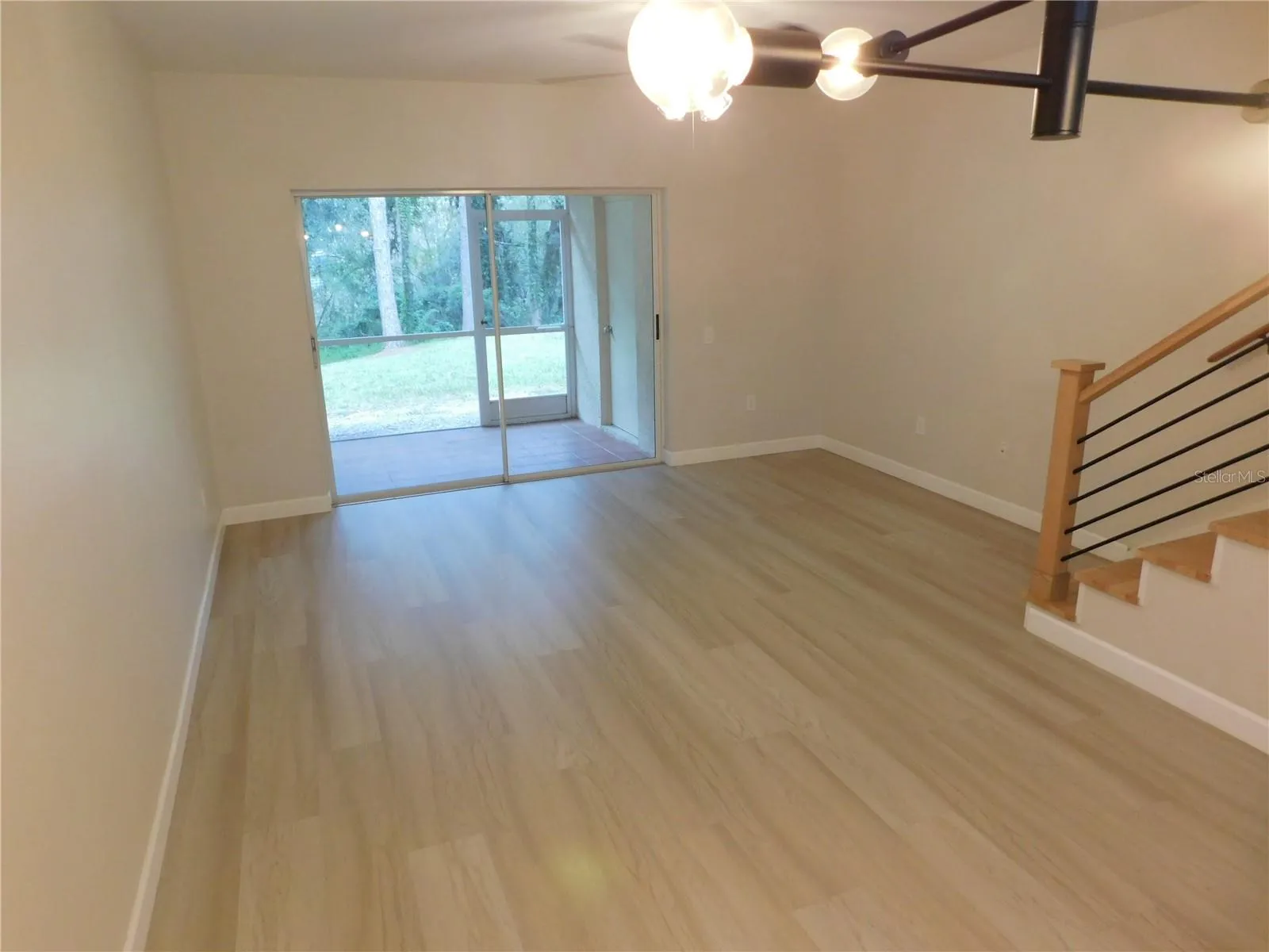 Living Area features new modern LVP and new Wood stairs for a modern finish