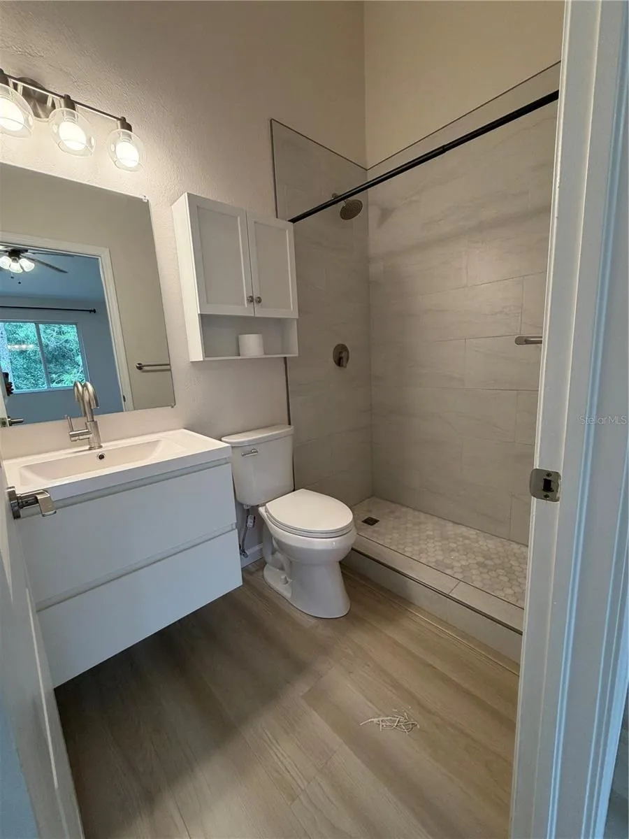 Primary 1 New Remodel Ensuite - Flooring, Shower tiles, Vanity and Faucet, Mirror, Toilet and Light Fixture.