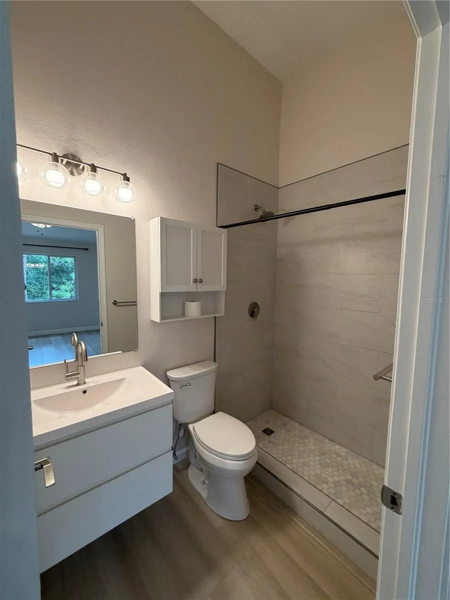 Primary 1 New Remodel Ensuite - Flooring, Shower tiles, Vanity and Faucet, Mirror, Toilet and Light Fixture.