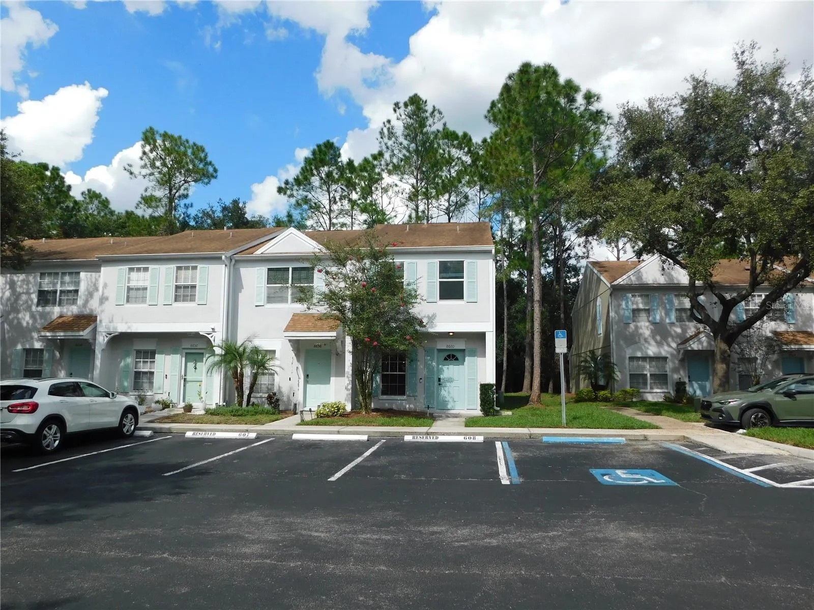Corner Unit with reserved parking space in front.