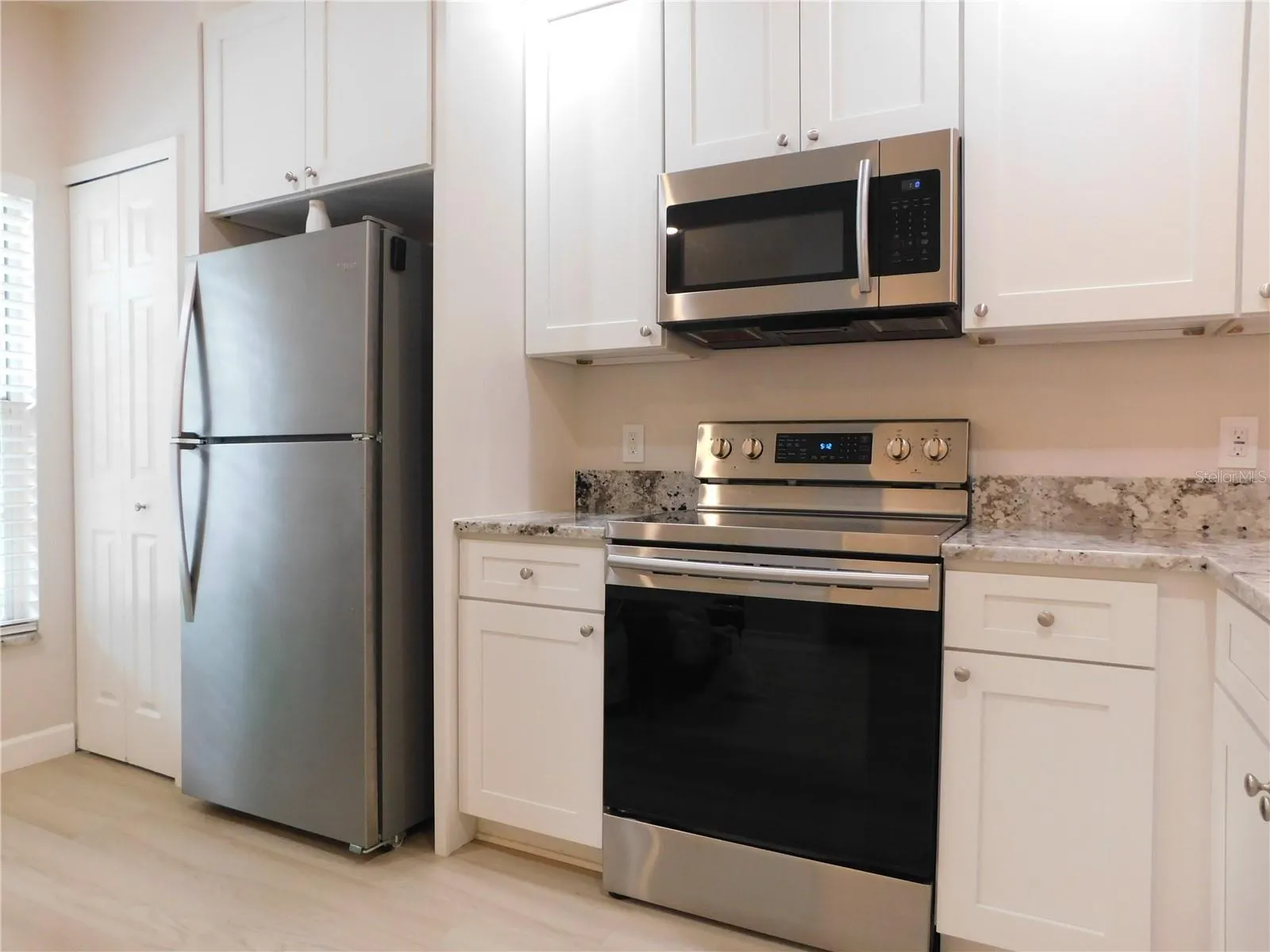 Remodeled Kitchen with new cabinets, gorgeous Granite counters and large ss deep sink.