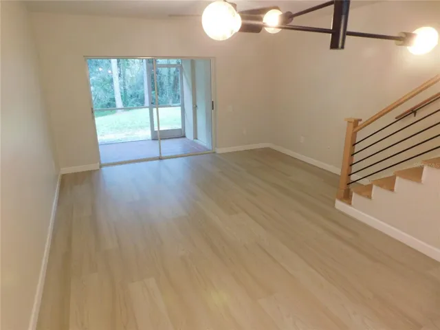 Living Area features new modern LVP and new Wood stairs for a modern finish