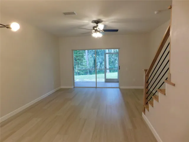 Living Area features new modern LVP and new Wood stairs for a modern finish