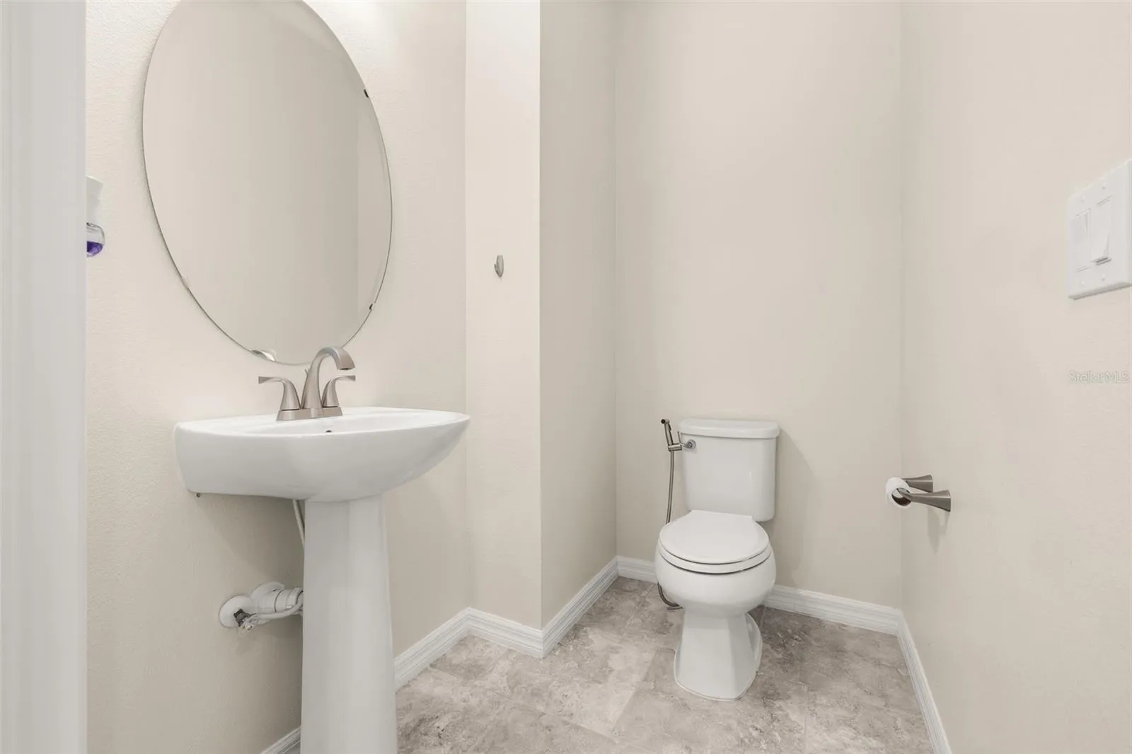 Half bathroom tucked behind the wall of the living room