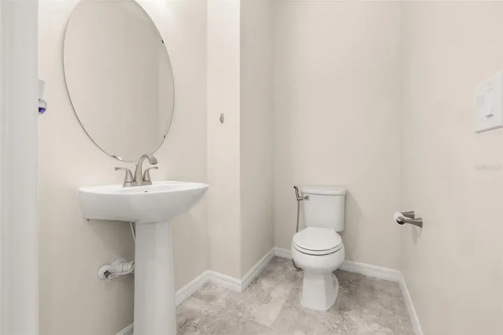 Half bathroom tucked behind the wall of the living room