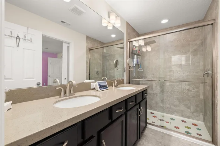Primary bathroom with a brand new shower enclosure and large vanity