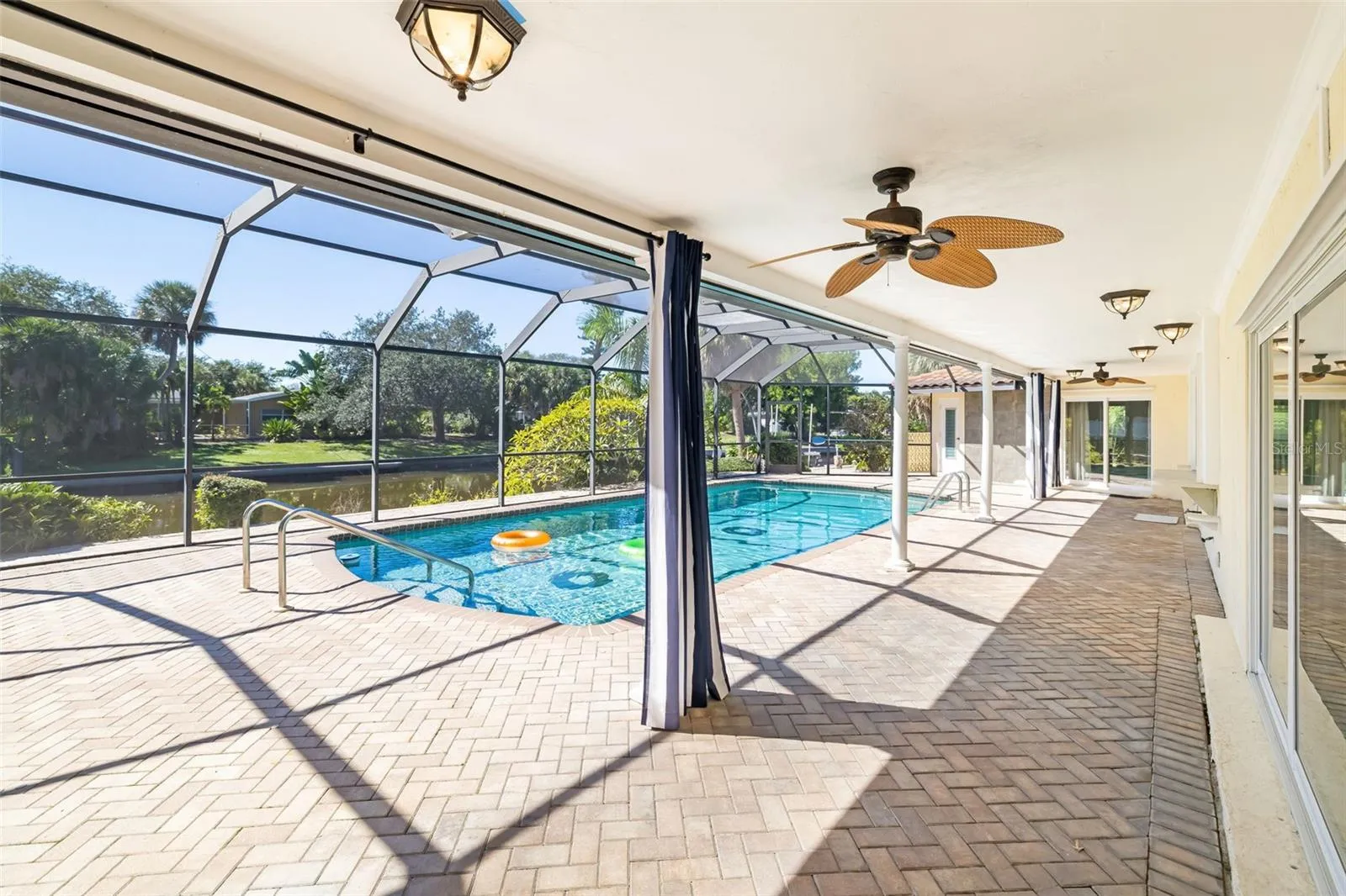 Covered area on patio overlooking pool and canal