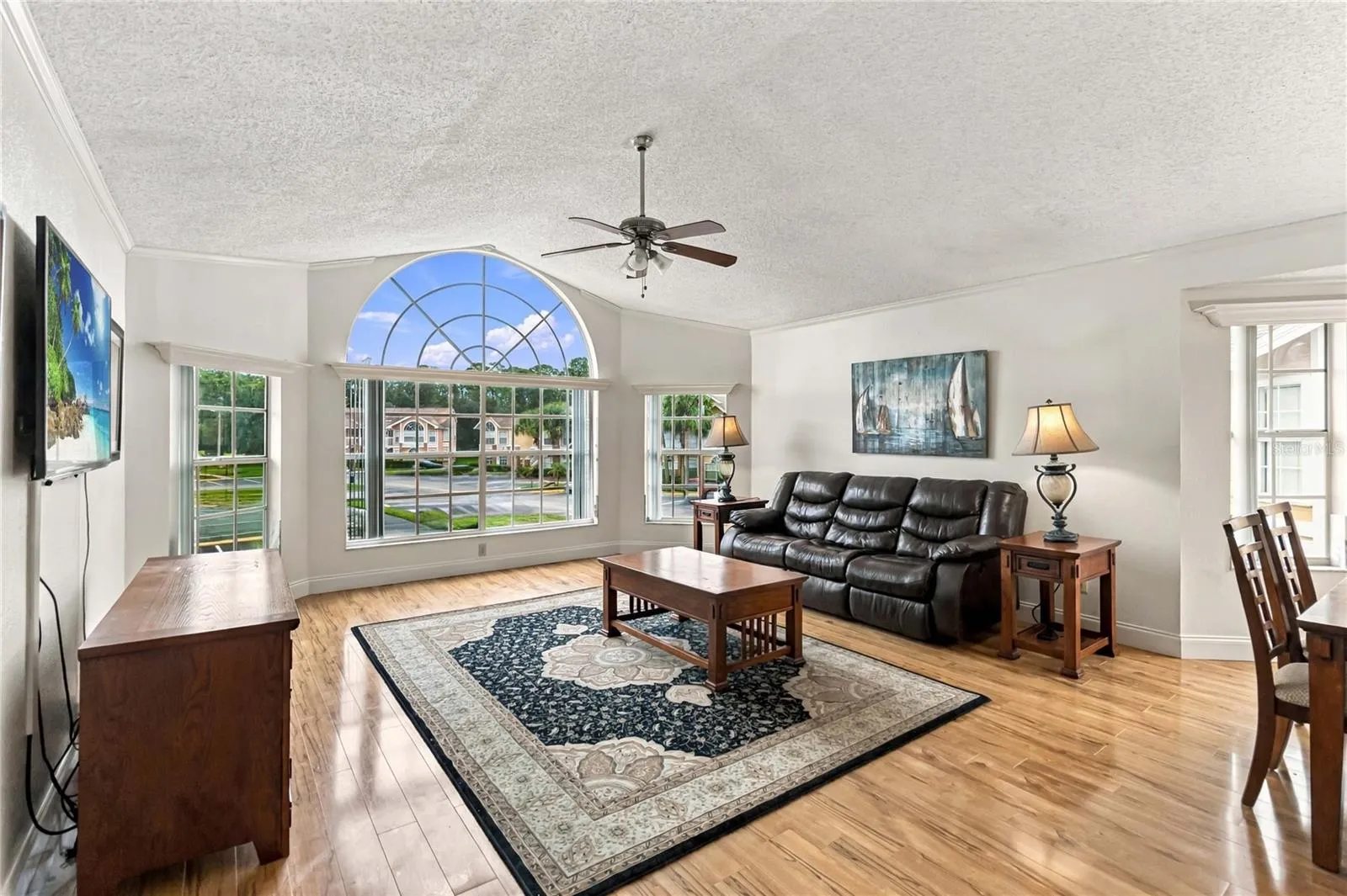 Living room with tall ceilings and windows