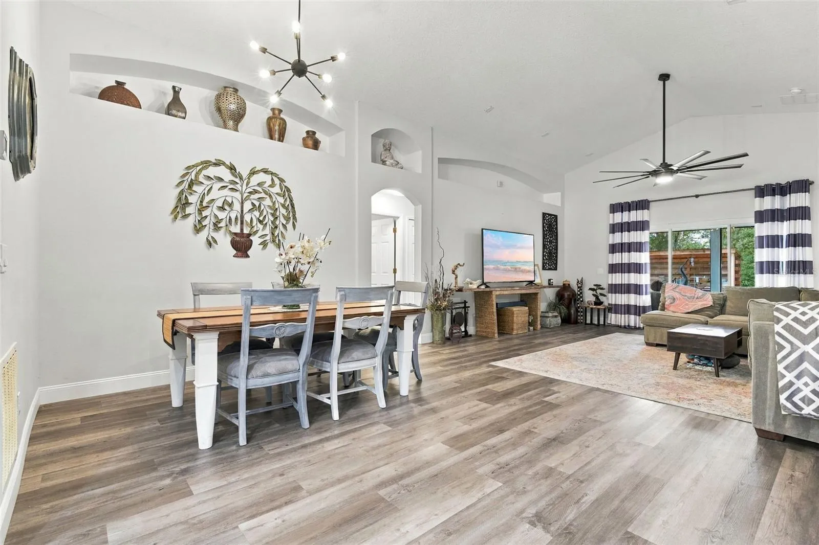 Dining and main living area. These soaring ceilings make it feel larger than it is.