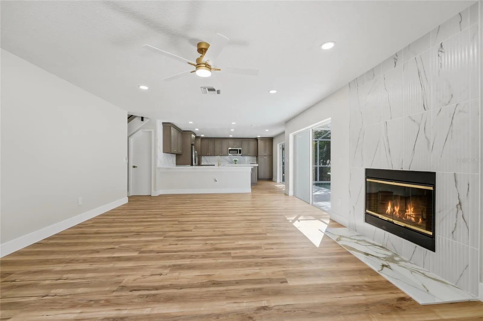 Floor-to-ceiling fluted tile fireplace