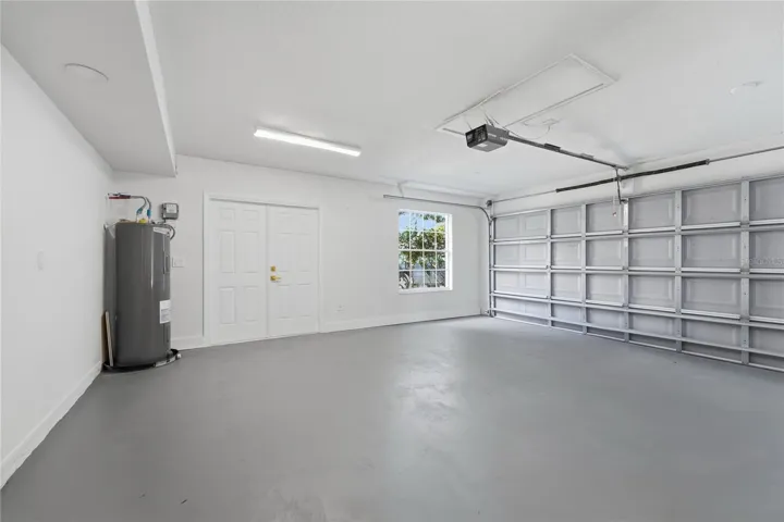 Spacious garage with generous parking space, windows for natural light, and a dedicated exit door.