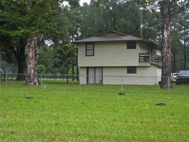 2 story house with deck on North and South sides on a Rainy day