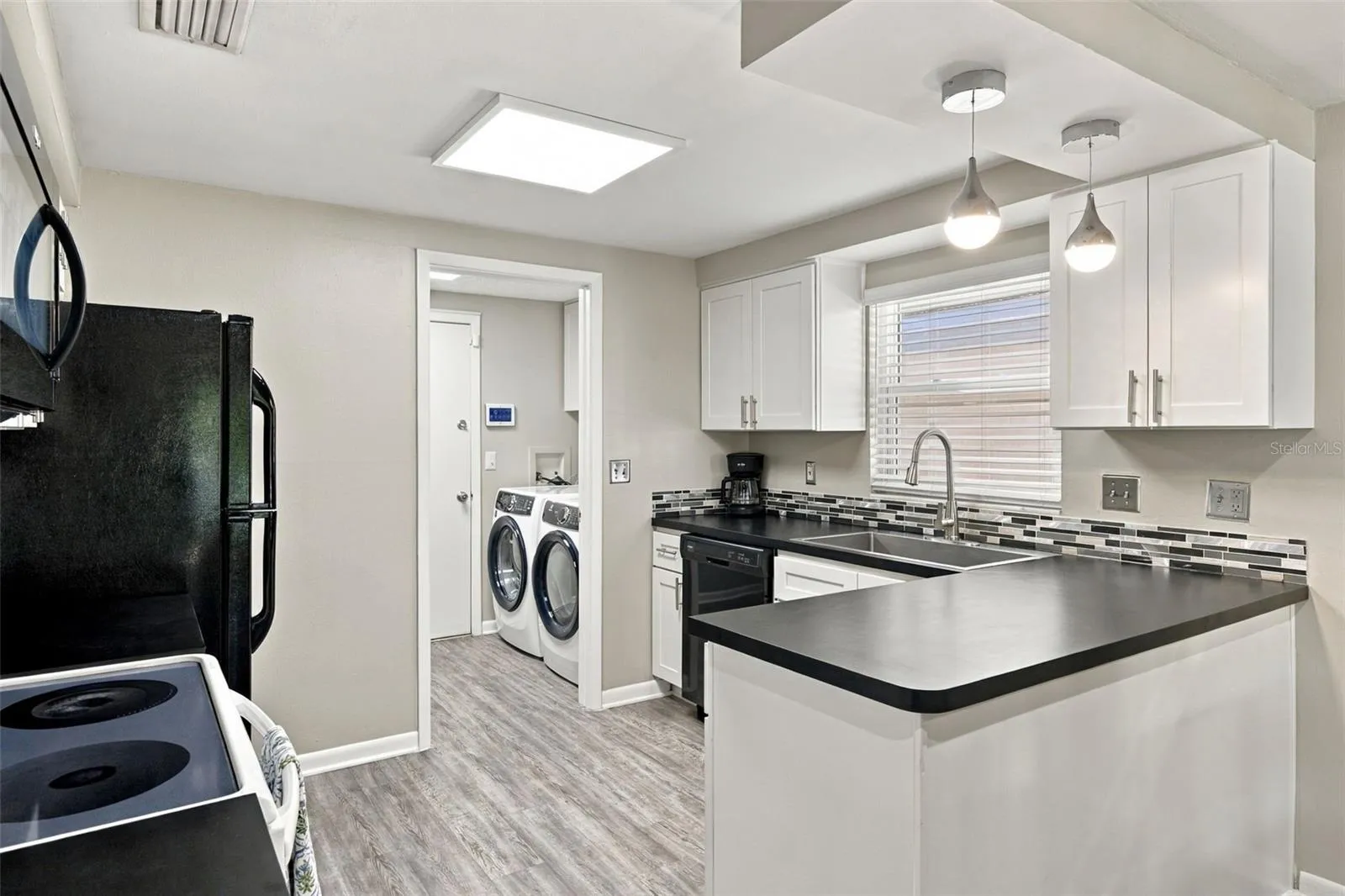 Kitchen features shaker-style cabinets with soft-close hardware