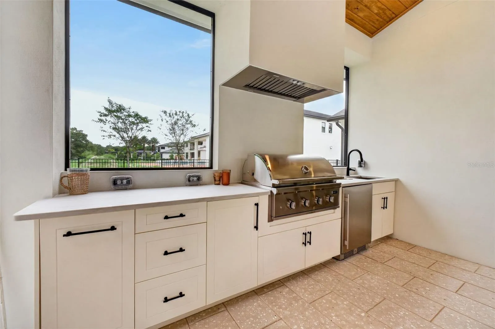 Summer kitchen complete with grill, hood, beverage refrigerator, sink and UV-stabilized High Density Polyethylene (HDPE) cabinetry