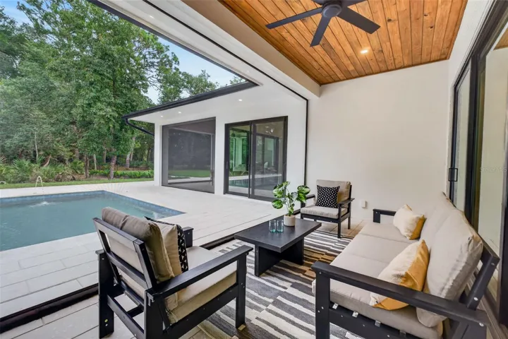 Covered porch with motorized retractable screens