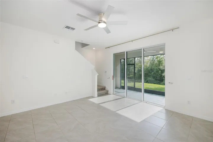 Living Room with Triple Sliders out to Lanai with Gorgeous View~