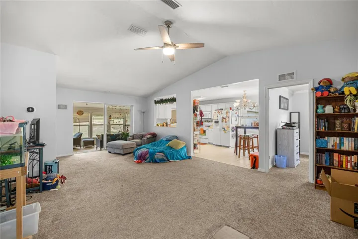 FROM FOYER LOOKING THRU LIVING AREA TO SUNROOM &amp; KITCHEN