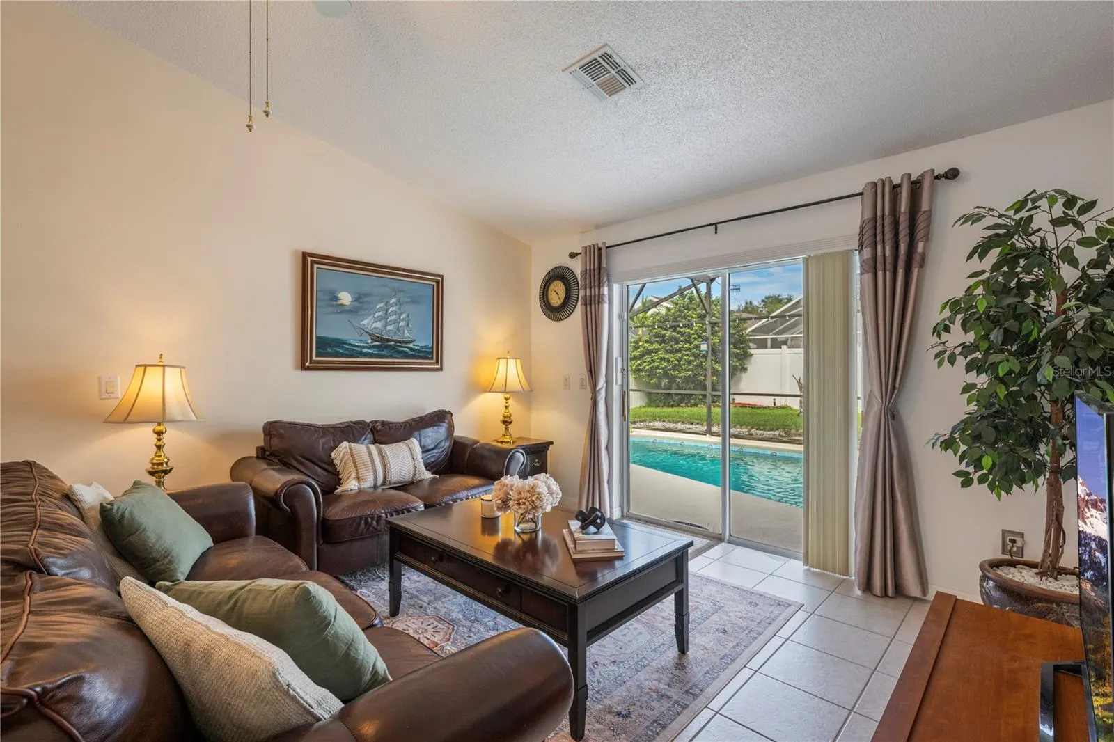 Living room with sliding glass doors to Pool and Patio