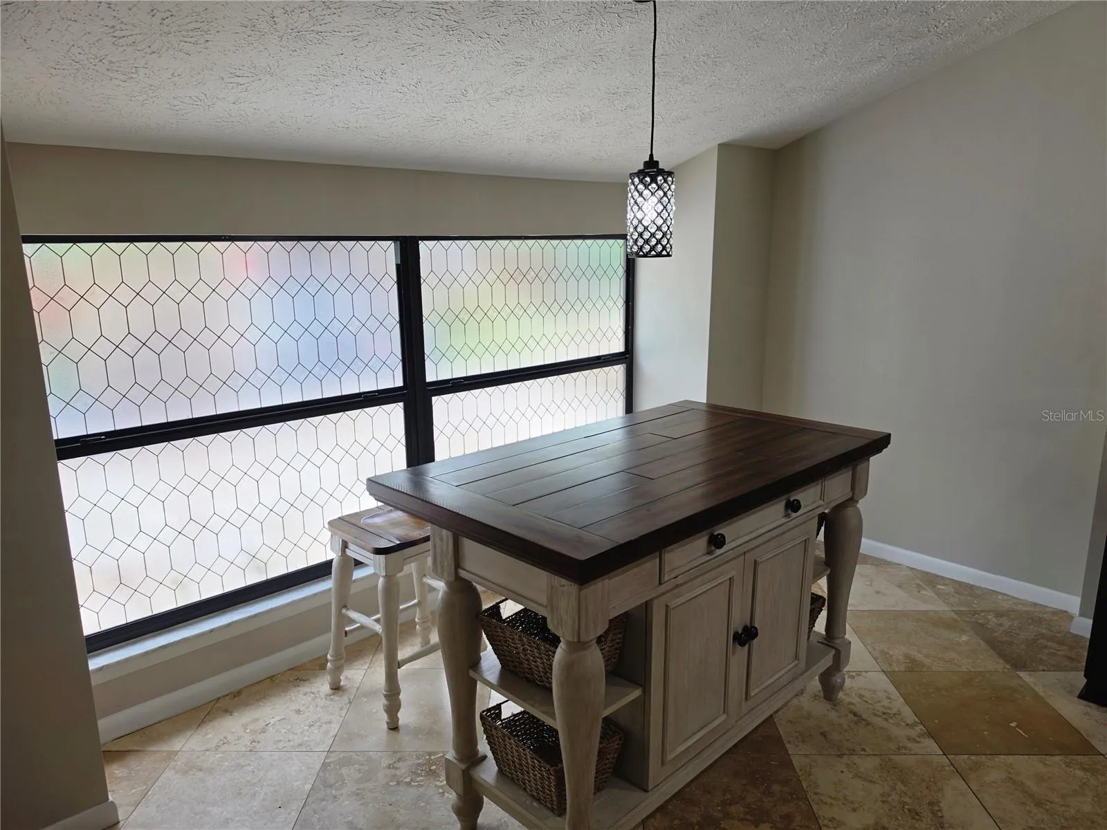 Dinette area includes island table and 2 stools
